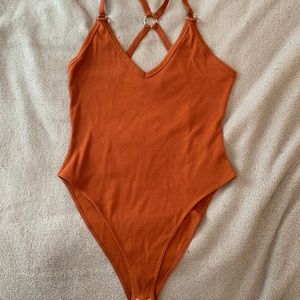 Burnt orange cross back bodysuit